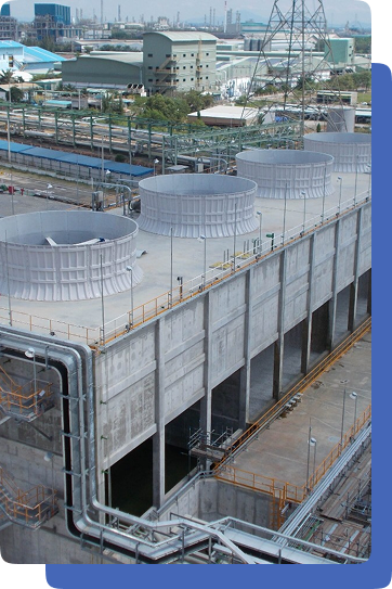 Large field-erected cooling tower cell bank with fan stacks and service pipework